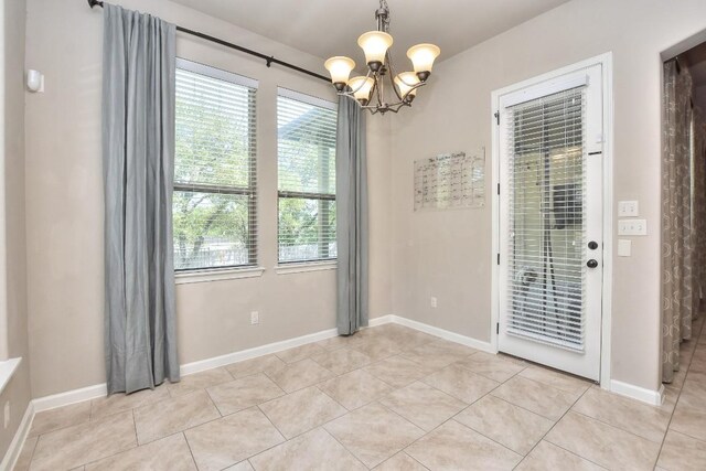 1706 Ambling Trl, Cedar Park, TX 78613 - empty room featuring a chandelier, light tile patterned flooring, and baseboards