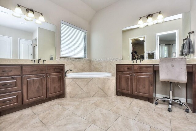 1706 Ambling Trl, Cedar Park, TX 78613 - full bathroom featuring tile patterned floors, two vanities, a garden tub, and lofted ceiling