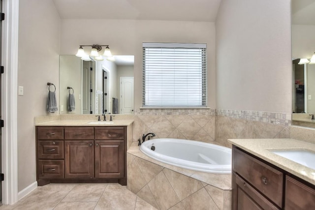 1706 Ambling Trl, Cedar Park, TX 78613 - bathroom with two vanities, a bath, and tile patterned flooring