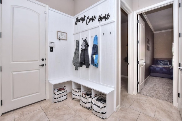 1706 Ambling Trl, Cedar Park, TX 78613 - mudroom featuring light tile patterned flooring, ornamental molding, and light colored carpet