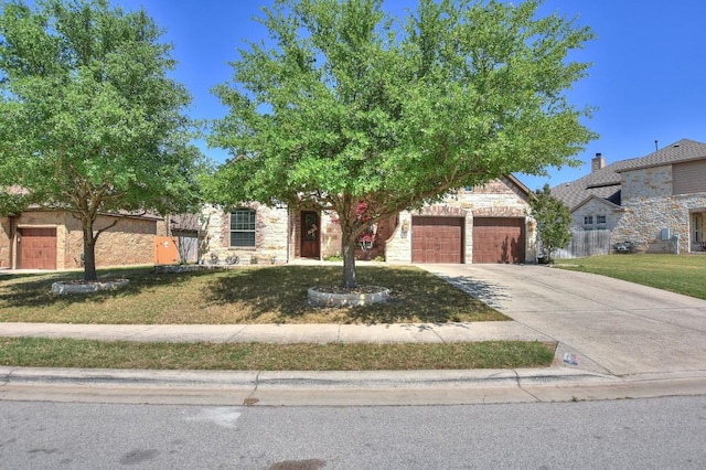 1706 Ambling Trl, Cedar Park, TX 78613 - view of property hidden behind natural elements with stone siding, concrete driveway, an attached garage, and a front yard