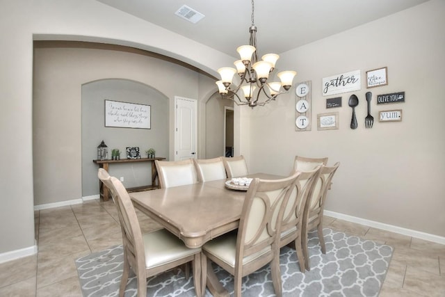 1706 Ambling Trl, Cedar Park, TX 78613 - dining room featuring a chandelier, arched walkways, light tile patterned flooring, and baseboards