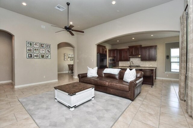 1706 Ambling Trl, Cedar Park, TX 78613 - living area with a ceiling fan, recessed lighting, arched walkways, light tile patterned floors, and baseboards