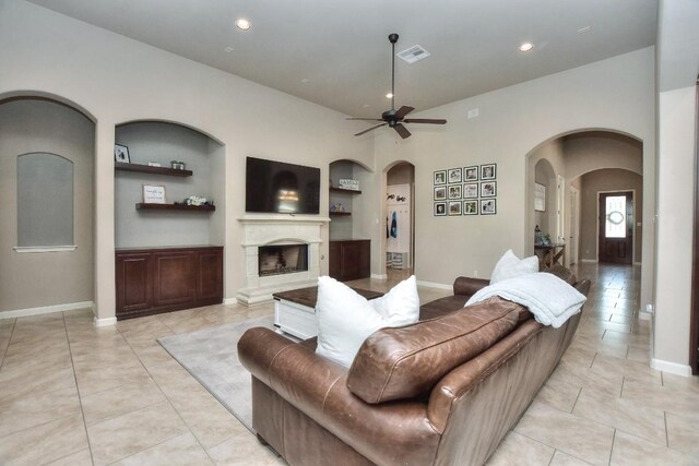 1706 Ambling Trl, Cedar Park, TX 78613 - living room with arched walkways, ceiling fan, built in features, light tile patterned floors, and recessed lighting