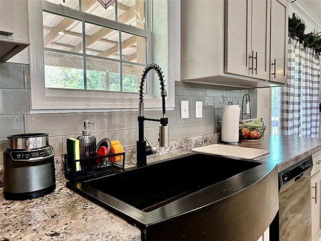 1021 Lewis Ln, Harwood, TX 78632 - kitchen featuring stainless steel dishwasher, tasteful backsplash, and light stone counters