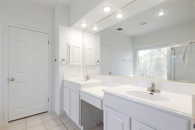 6008 Sierra Leon St, Austin, TX 78759 - bathroom with double vanity, a shower stall, tile patterned flooring, and recessed lighting