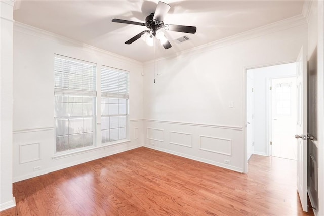 6008 Sierra Leon St, Austin, TX 78759 - empty room featuring ornamental molding, a ceiling fan, light wood-style floors, and wainscoting