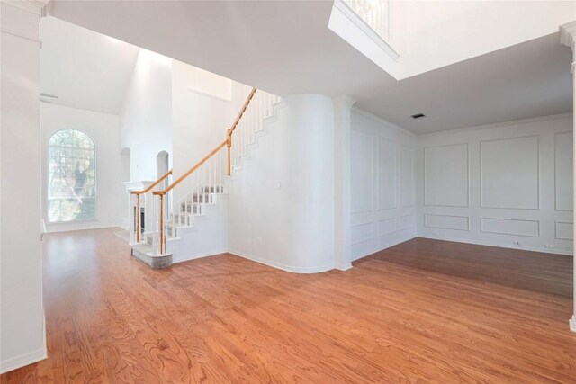 6008 Sierra Leon St, Austin, TX 78759 - unfurnished room featuring stairway, light wood-style flooring, and arched walkways
