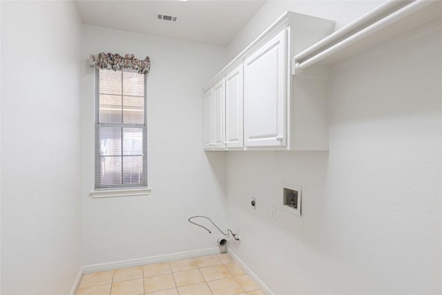 6008 Sierra Leon St, Austin, TX 78759 - laundry area featuring hookup for a gas dryer, cabinet space, light tile patterned floors, washer hookup, and electric dryer hookup