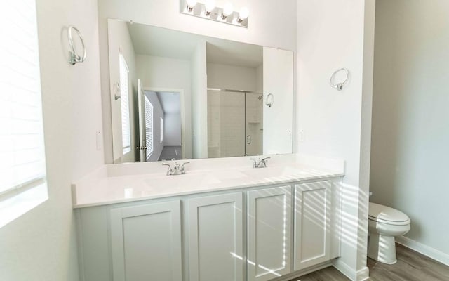 510 Timber Brook Dr, Hutto, TX 78634 - bathroom with double vanity, a shower stall, toilet, and a sink