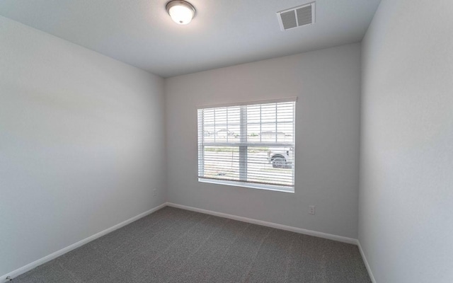 510 Timber Brook Dr, Hutto, TX 78634 - empty room featuring baseboards, visible vents, and dark carpet