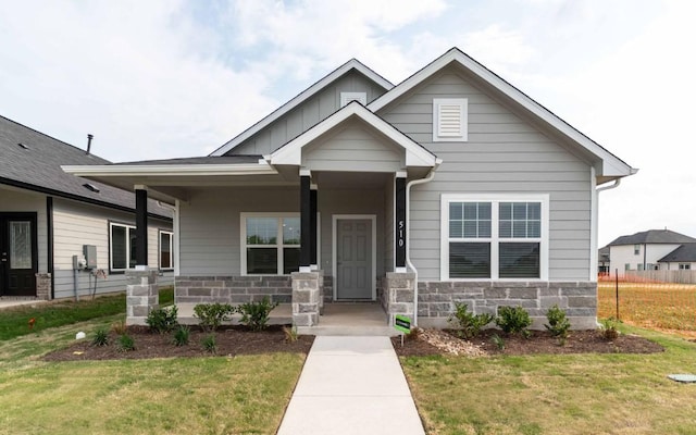 510 Timber Brook Dr, Hutto, TX 78634 - craftsman-style house with board and batten siding, stone siding, covered porch, and a front yard