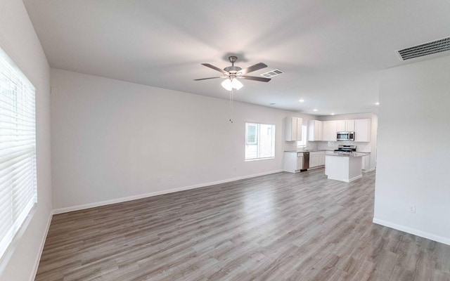 510 Timber Brook Dr, Hutto, TX 78634 - unfurnished living room with ceiling fan, light wood finished floors, baseboards, visible vents, and recessed lighting