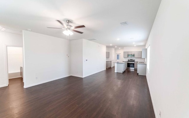 108 Biscayne Dr, Hutto, TX 78634 - unfurnished living room with ceiling fan, baseboards, dark wood-style flooring, visible vents, and recessed lighting