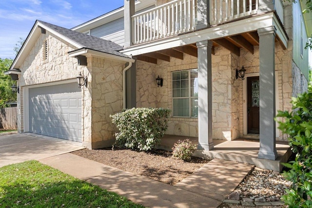 901 Middle Brook Dr, Leander, TX 78641 - view of exterior entry with stone siding, a balcony, an attached garage, a shingled roof, and driveway