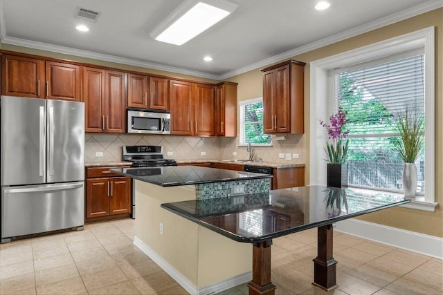 901 Middle Brook Dr, Leander, TX 78641 - kitchen featuring visible vents, a center island, a sink, appliances with stainless steel finishes, and backsplash