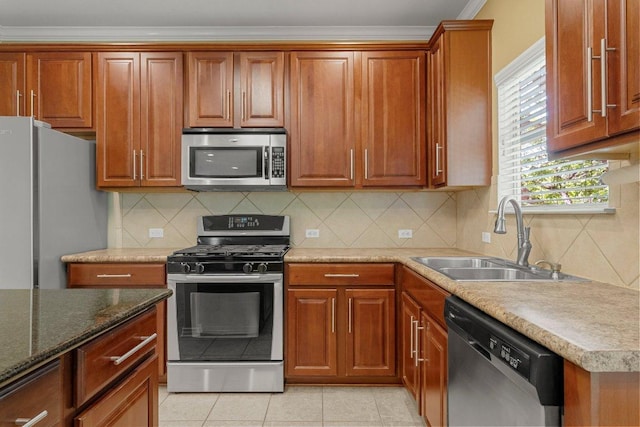 901 Middle Brook Dr, Leander, TX 78641 - kitchen featuring a sink, ornamental molding, brown cabinetry, stainless steel appliances, and backsplash