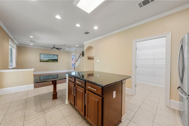 901 Middle Brook Dr, Leander, TX 78641 - kitchen featuring recessed lighting, a center island, freestanding refrigerator, crown molding, and visible vents