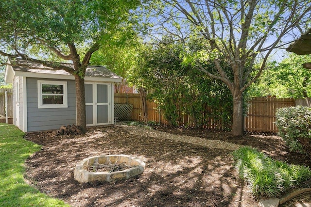 901 Middle Brook Dr, Leander, TX 78641 - view of yard featuring an outbuilding, a storage shed, fence, and a fire pit