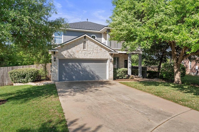 901 Middle Brook Dr, Leander, TX 78641 - traditional-style house with driveway, stone siding, a front yard, a garage, and fence