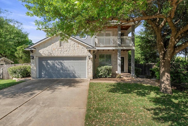 901 Middle Brook Dr, Leander, TX 78641 - view of front of property featuring fence, stone siding, a balcony, an attached garage, and concrete driveway