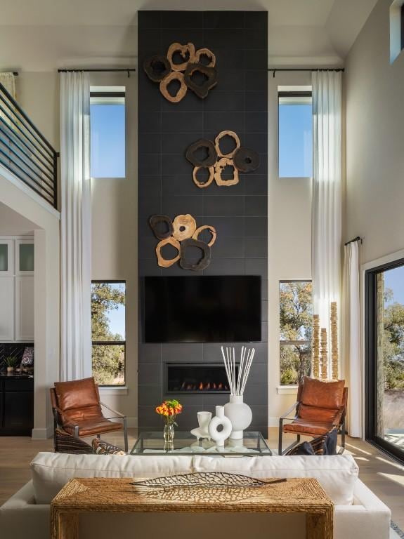 2002 Clearlight Ln, Georgetown, TX 78633 - living room featuring a high ceiling, wood finished floors, and healthy amount of natural light