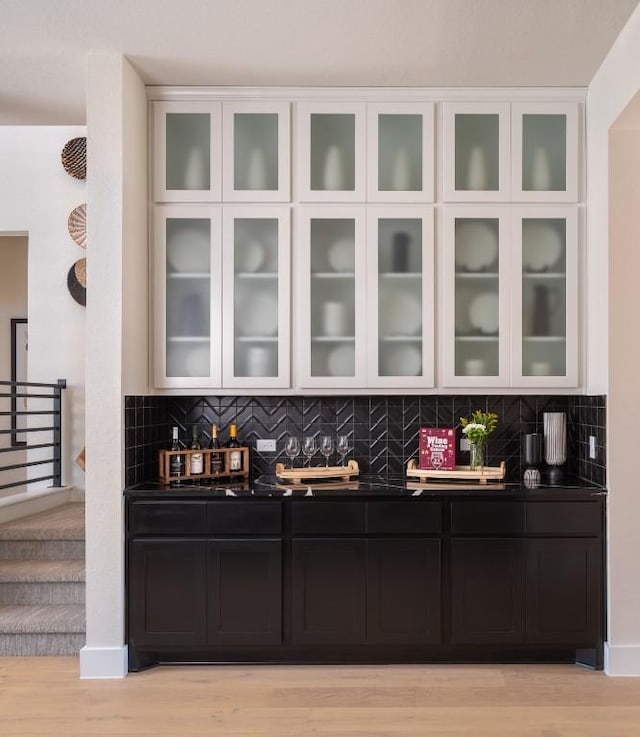 2002 Clearlight Ln, Georgetown, TX 78633 - bar featuring tasteful backsplash, light wood-style flooring, and stairway