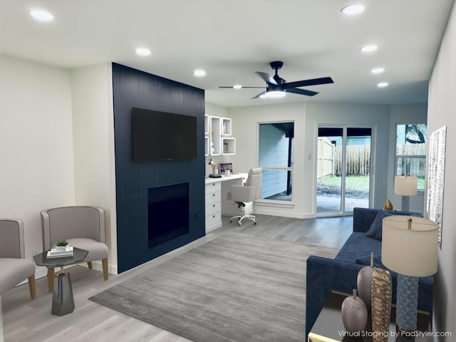 living room featuring baseboards, a ceiling fan, light wood-style floors, recessed lighting, and a large fireplace