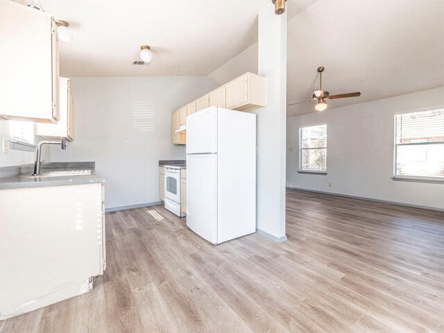 9624 Sugar Hill Dr Unit A & B, Austin, TX 78748 - kitchen with white appliances, vaulted ceiling, ceiling fan, light wood-style flooring, and white cabinetry