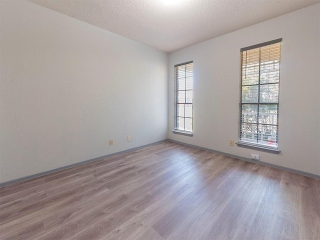 9624 Sugar Hill Dr Unit A & B, Austin, TX 78748 - spare room featuring wood finished floors and a textured ceiling