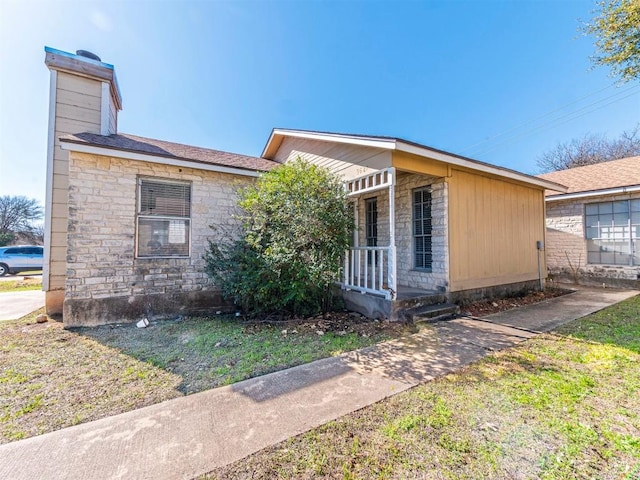 9624 Sugar Hill Dr Unit A & B, Austin, TX 78748 - view of front facade with stone siding, a chimney, covered porch, and a front lawn