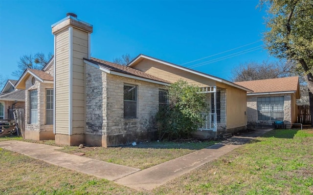 9624 Sugar Hill Dr Unit A & B, Austin, TX 78748 - view of side of property with stone siding, a lawn, and a chimney