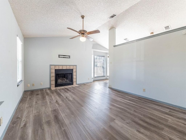 9624 Sugar Hill Dr Unit A & B, Austin, TX 78748 - unfurnished living room with ceiling fan, a textured ceiling, wood finished floors, a fireplace, and vaulted ceiling