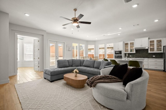 431 Wild Pecan Loop, Buda, TX 78610 - living room featuring healthy amount of natural light, light wood-style floors, ceiling fan, and recessed lighting