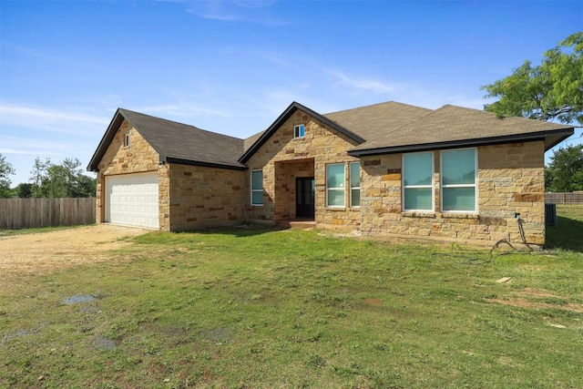 view of front facade with stone siding, driveway, and roof with shingles
