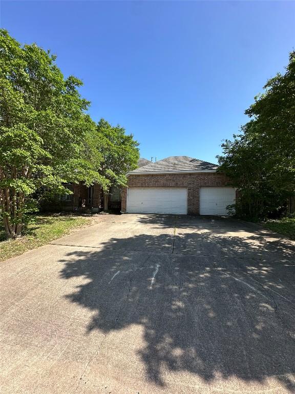 exterior space with a garage and concrete driveway