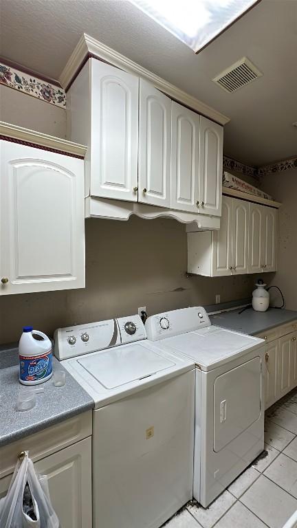 1710 Muledeer Run, Leander, TX 78641 - washroom with cabinet space, independent washer and dryer, ornamental molding, and light tile patterned floors