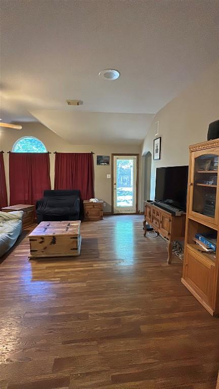 1710 Muledeer Run, Leander, TX 78641 - living area featuring vaulted ceiling and wood finished floors