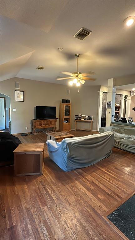 living room with wood finished floors, a ceiling fan, and visible vents