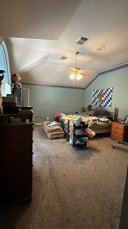 carpeted bedroom featuring visible vents, ceiling fan, and lofted ceiling