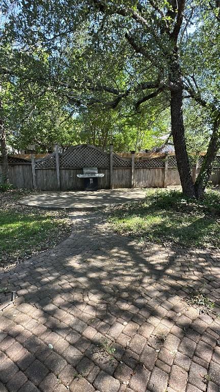 wooden terrace featuring a patio and fence