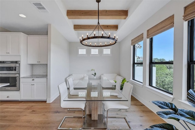 19605 Summit Glory Trl Unit 107, Spicewood, TX 78669 - dining area featuring light wood-type flooring, visible vents, beam ceiling, and an inviting chandelier