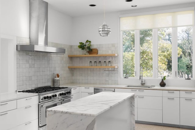 5204 Ridge Oak Dr, Austin, TX 78731 - kitchen featuring appliances with stainless steel finishes, exhaust hood, white cabinetry, a center island, and backsplash