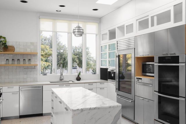 5204 Ridge Oak Dr, Austin, TX 78731 - kitchen featuring stainless steel appliances, backsplash, a kitchen island, plenty of natural light, and recessed lighting