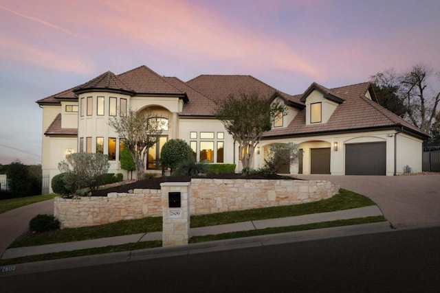 2809 Waterbank Cv, Austin, TX 78746 - french country inspired facade featuring an attached garage, driveway, and stucco siding