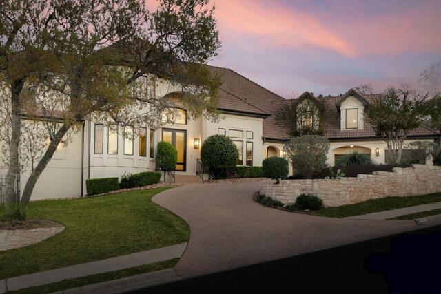 2809 Waterbank Cv, Austin, TX 78746 - french country home featuring driveway, stucco siding, a yard, and a tiled roof