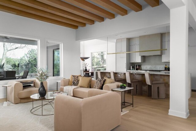 2809 Waterbank Cv, Austin, TX 78746 - living room featuring beam ceiling, plenty of natural light, and light wood-type flooring