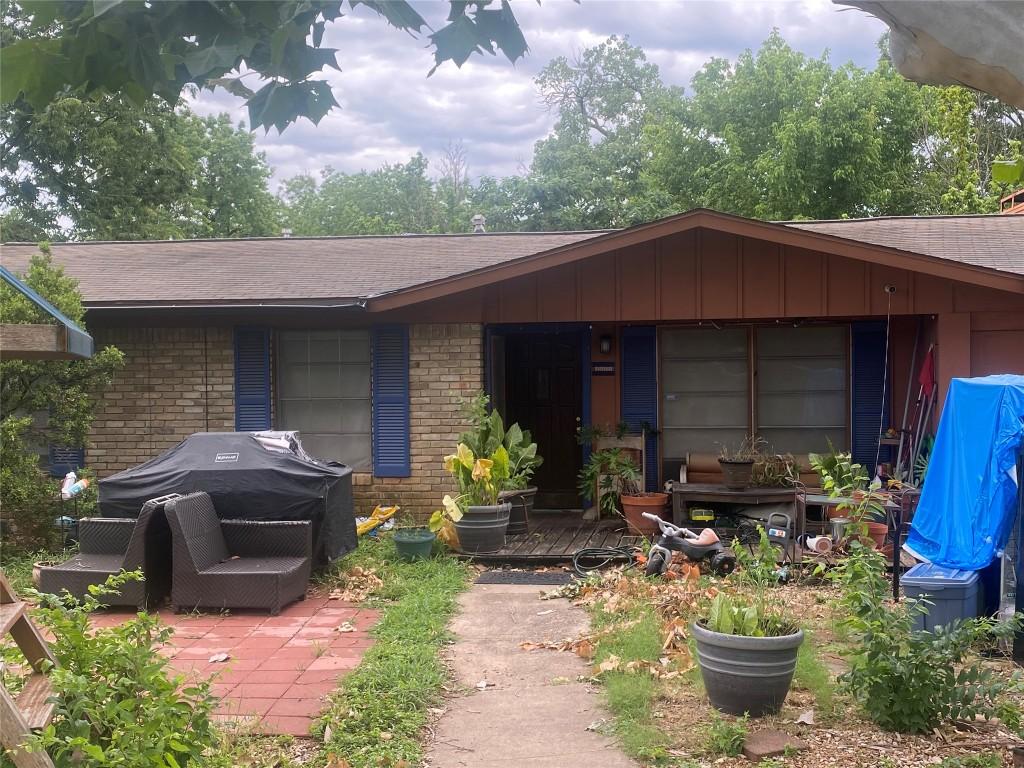 4623 Philco Dr, Austin, TX 78745 - view of front facade featuring brick siding, roof with shingles, and a patio