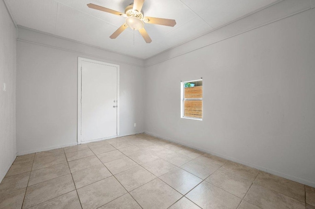 spare room featuring light tile patterned floors and a ceiling fan