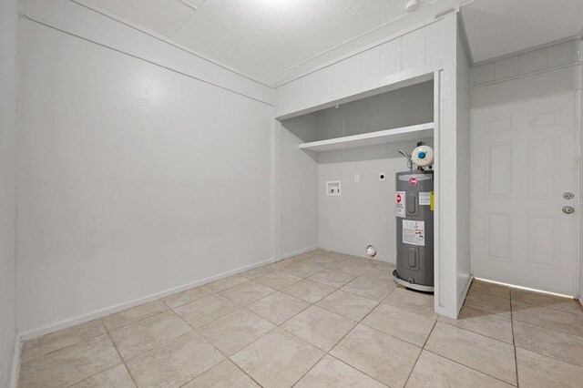 washroom featuring washer hookup, hookup for an electric dryer, laundry area, light tile patterned floors, and water heater
